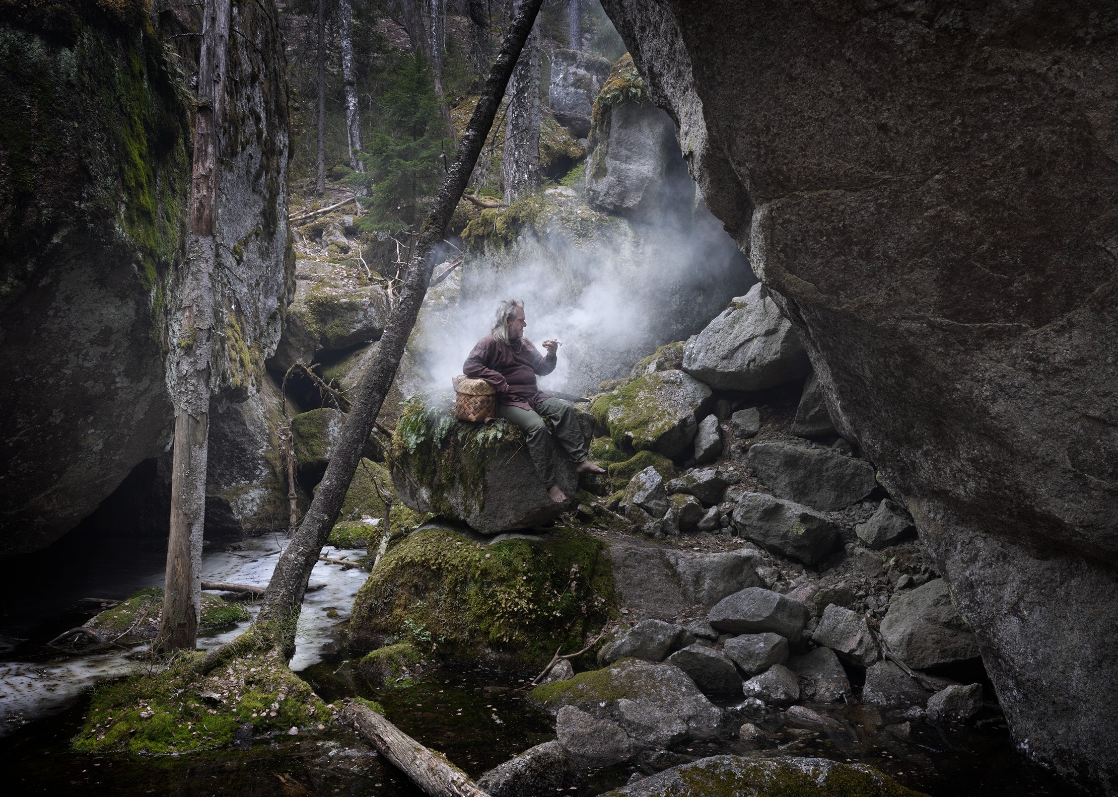 Troll sitting on a rock in the misty forest.
