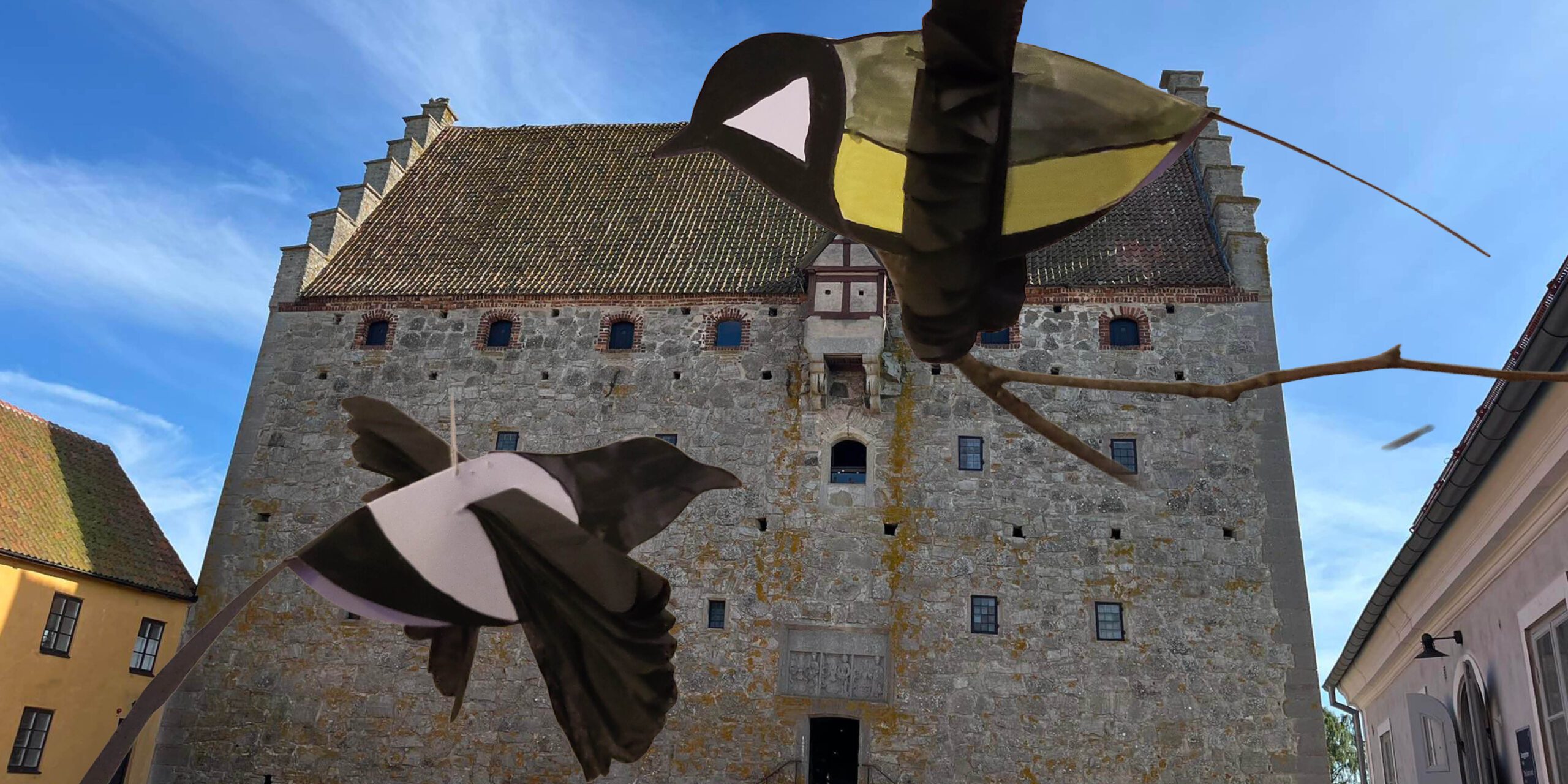 Paperbirds are flying in front of the castle